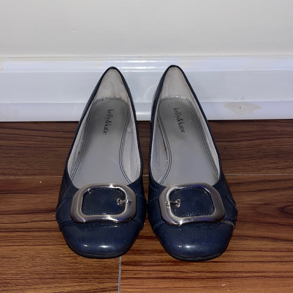 dark grey flats with a small heel and buckle strap